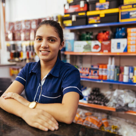 Young latin woman working in hardware store